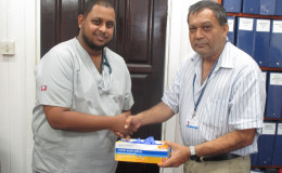 In photo Dr. Aftaab Aliahmad (left) is seen with GPHC’s Chief Executive Officer,  Michael Khan
