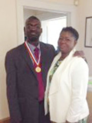Aubrey Quamina with his wife Viola and his medal.