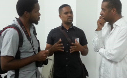 Filmmaker  Kojo McPherson (left) and Guyana’s Film Coordinator Richard Pitman (centre) in discussion with a member of the Haitian Film coordinating team, Jean Phillipe Chevallier