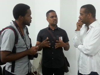 Filmmaker  Kojo McPherson (left) and Guyana’s Film Coordinator Richard Pitman (centre) in discussion with a member of the Haitian Film coordinating team, Jean Phillipe Chevallier