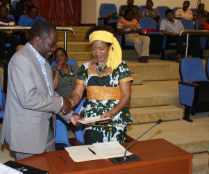 Vice Chancellor Jacob Opadeyi being handed the partnership agreement by Professor Verene Shepard of UWI- Institute of Gender and Developmental Studies Jamaica