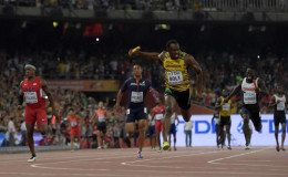 Usain Bolt runs the anchor leg on the Jamaica 4 x 100m relay that won in 37.36 during the IAAF World Championships in Athletics at National Stadium yesterday. From left: Michael Rodgers (USA), Jimmy Vicaut (FRA), Botl and Justyn Warner (CAN).