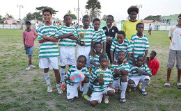 The newly crowned I-Net Communications u-13 champions Santos FC posing with their prizes following their win over hosts Fruta Conquerors at the Tucville Community ground.