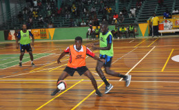 Okeene Fraser of Bent Street trying to maintain possession of the ball while being challenged by North Ruimveldt’s Joshua Browne during their group-D affair in the GT Beer Futsal Championship 