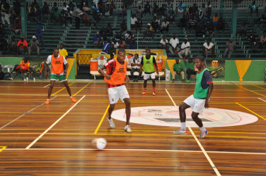 Hubert Pedro (green) of West Front Road-Gold is Money in the process of completing a pass while being challenged by Showstopper’s Anthony Sancho during their GT Beer Futsal championship group-C matchup.