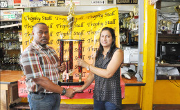 Petra Organization Co-Director and tournament coordinator Troy Mendonca (left) collecting the championship trophy from Trophy Stall’s Devi Sunich during the simple presentation ceremony