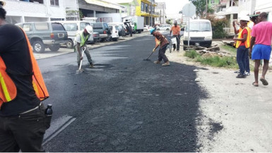 Workers from the Ministry of Public Infrastructure resurfacing part of Albert Street. (Public Infrastructure Ministry photo)