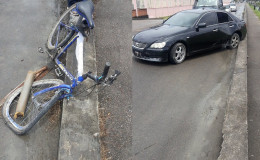 Aftermath: The mangled bicycle after William Nurse and Lisa Khedoo were struck last Sunday morning. At right is the car. 