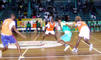 Flashback- Sophia’s Dwayne Lowe (green) trying to maintain possession of the ball while being surrounded by West Front Road-Gold is Money’s Michael Pedro (right), Michael Oie (centre) and Wendell Pedro (left) during their earlier group-C showdown. 