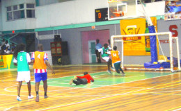 Randolph Wagner (left/green) of West Front Road-Gold scoring his team’s opening goal during their hard-fought win over West Back Road in the GT Beer Futsal Championship at the Cliff Anderson Sports Hall
