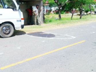 The chalk-marked section of the road where the motorcycle was
