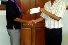 President of the Guyana Volleyball Federation (GVF) Omar Flores receives the donation from Latoya Johnson of the `Reds’ Perreira Foundation.
