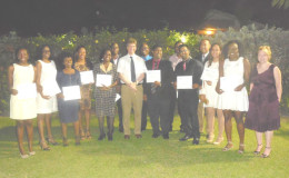 British High Commissioner to Guyana Greg Quinn (centre) and his wife, Wendy Quinn (far right), pose with the 13 Chevening Scholarship recipients at a farewell reception at the Commissioner’s residence on Wednesday night. 