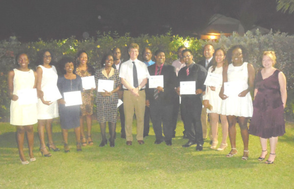 British High Commissioner to Guyana Greg Quinn (centre) and his wife, Wendy Quinn (far right), pose with the 13 Chevening Scholarship recipients at a farewell reception at the Commissioner’s residence on Wednesday night. 