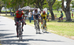 Junior Niles biking to victory ahead of Akeem Wilkinson and Shaquel Agard in a thrilling three-man sprint finish yesterday at the National Park. (Orlando Charles photo)
