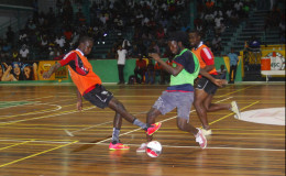 Flashback- Daniel Wilson (left) of Bent Street in the process of tackling his name sake Daniel Favourite (green) of Festival City during their team’s semi-final showdown in the inaugural GT Beer Futsal Championship at the Cliff Anderson Sports Hall