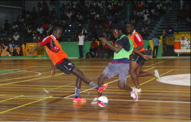 Flashback- Daniel Wilson (left) of Bent Street in the process of tackling his name sake Daniel Favourite (green) of Festival City during their team’s semi-final showdown in the inaugural GT Beer Futsal Championship at the Cliff Anderson Sports Hall