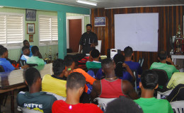 Top End Performance Gym Instructor and motivational speaker Kezqweyah Yisrael speaks with members of the Guyana Jags team.
