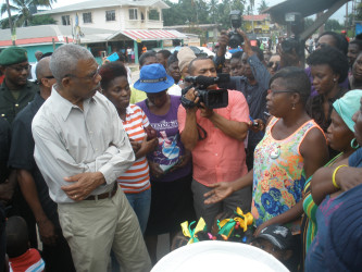 President David Granger listening to concerns of residents at Blueberry Hill yesterday 