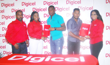 Chris Barnwell and Devendra Bishoo receive their ambassador contracts from Digicel executives Louanna Abrams and Vidya Sanichara as Rameshwhar Rupchand looks on. 