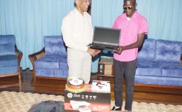  President David Granger handing over the laptop and other equipment to 18-year old Ceion Rollox at the Ministry of the Presidency (GINA photo)