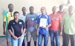 Members of the Bartica Football Association pose with Guyana Football Federation (GFF) General Secretary Richard Groden and Assistant General Secretary Diedre Davis following the adoption of their constitution.