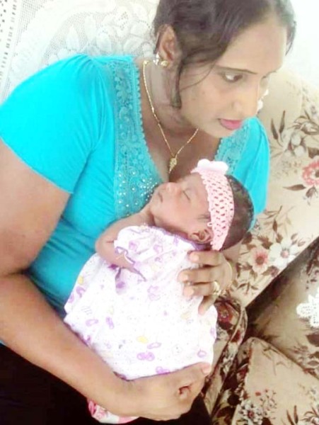 Omawattie Samaroo with her infant daughter 