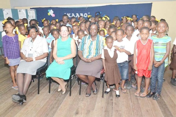 First Lady Sandra Granger (centre) poses with some of the children of the Remedial Project and officials 