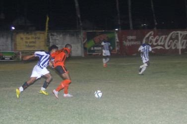 Jolanshoy McDowall (second left) of Slingerz FC trying to keep possession of the ball while being challenged by a GFC player during their GFF Stag Beer Elite League matchup at the GFC ground in Bourda on Wednesday. 