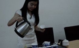 A member of the Confucius institute demonstrates the Chinese art of brewing tea