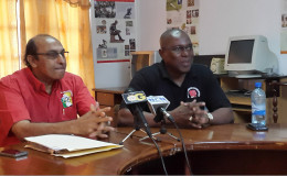 Steve Ninvalle (right) addressing the gathering during the launch of the Goodwill/Caribbean Development Boxing Championship yesterday at the Guyana Olympic House while GOA President Karan Juman-Yassin looks on 