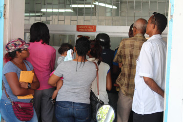 Some members of the public waiting to pay their taxes at City Hall yesterday. 