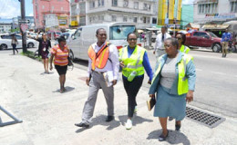 Minister Simona Broomes (centre) and team on Regent Street as they inspected stores and interacted with employees. (GINA photo)