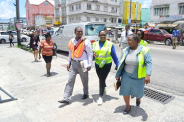 Minister Simona Broomes (centre) and team on Regent Street as they inspected stores and interacted with employees. (GINA photo) 