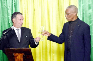 President David Granger (right)  and Brazilian Ambassador, Lineu Pupo De Paula proposing a toast to the good health of President Dilma Rouseff, President of the Federative Republic of Brazil. (Ministry of the Presidency photo)     