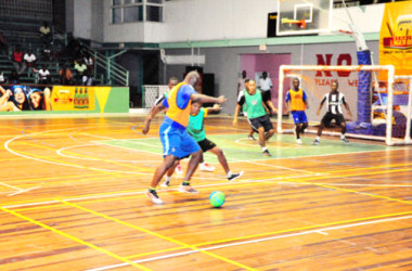 Flashback- Dennis Edwards (orange) of Sparta Boss trying to dribble Globe Yard’s Anthony Francis during their team’s earlier fixture in the GT Beer Futsal Championship
 
