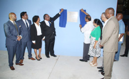 Prime Minister Moses Nagamootoo (fourth, right) and Dennis Beepat (fourth, left) unveil the plaque at the opening of the Beepat Warehouse facility at Dennis Street, Sophia on Saturday night. Also in photo are Minister of State Joseph Harmon, Minister of Business Dominic Gaskin, Mrs Sita Nagamootoo and principals of the company.