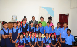 First Vice President and Prime Minister Moses Nagamootoo poses with students and teachers of Port Kaituma Primary School during a visit to his office today