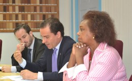Regional Representative of the Regional Office for Central America and the Caribbean for the UNODC, Amado Philip de Andres (centre) makes a point to Minister Raphael Trotman at the meeting, earlier today. UN Resident Representative Khadija Musa is at left. (Ministry of the Presidency photo)
