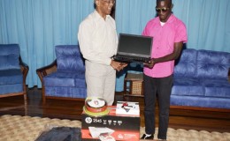President David Granger handing over the laptop (GINA photo)