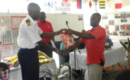 Harbour Master Michael Tennant hands over a gift to Best Captain Roy King (right), Vreed-en-Hoop to Georgetown route