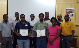 Participants pose with their certificates at the end of training, along with other bureau staff.
