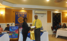 Elizabeth Cox, the President of the Rotary Club of Georgetown receiving a cheque from Brian Hackett, a Scotiabank representative, at the Cervical Cancer Campaign launch.
