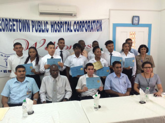 Orthopaedic Graduation: The ten students holding their certificates with coordinator Dr Kaaleshwar Ramcharran (seated at extreme left), and acting CEO of the GPHC Allan Johnson (seated second from left)