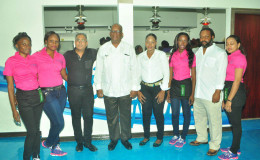 Owner of the Bistro Azure Ryan Fields (second, right), Minister of Finance Winston Jordan (fifth, right) and Owner of Giftland Mall, Roy Beepat, (third, left) pose for a photo with staff of the Bistro during its grand opening on Thursday night. 