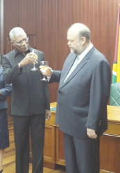 President David Granger shares a toast with newly-accredited United States Ambassador Perry Holloway yesterday  
