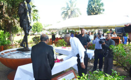 Indian High Commissioner Shri Mahalingam (Left) and President David Granger (Right) laying a floral tribute at the Gandhi statue in the Promenade Gardens. 