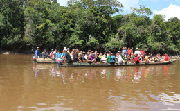 A meeting on the river: Travellers meet on the “highway” of Region Seven, the Mazaruni River.
