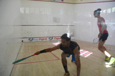 Peter Michael DeGroot (left) in the process of unleashing a shot against Taylor Fernandes during their Open Divisional finale in the Lucozade Handicap Squash Championship at the Georgetown Club Facility 