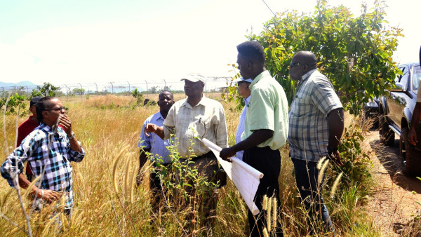 Minister Joseph Harmon (fourth from left) surveys the proposed site for the setting up of a warehouse to store food and other essentials for emergency purposes.  (Ministry of the Presidency photo) 